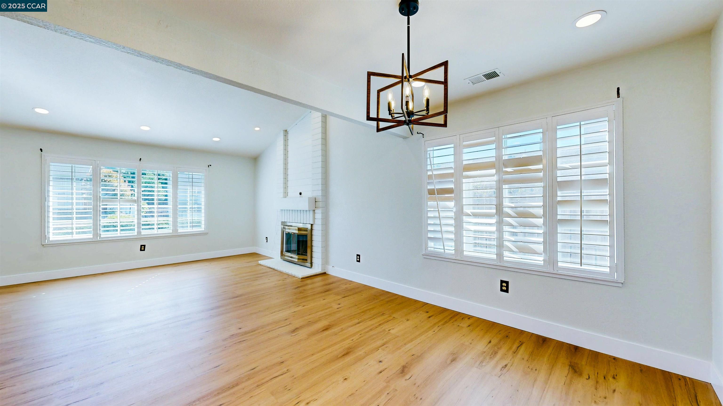 3743 Painted Pony Road Richmond, CA 94803 - Photo 17 of 56 a view of a room with wooden floor a ceiling fan and windows