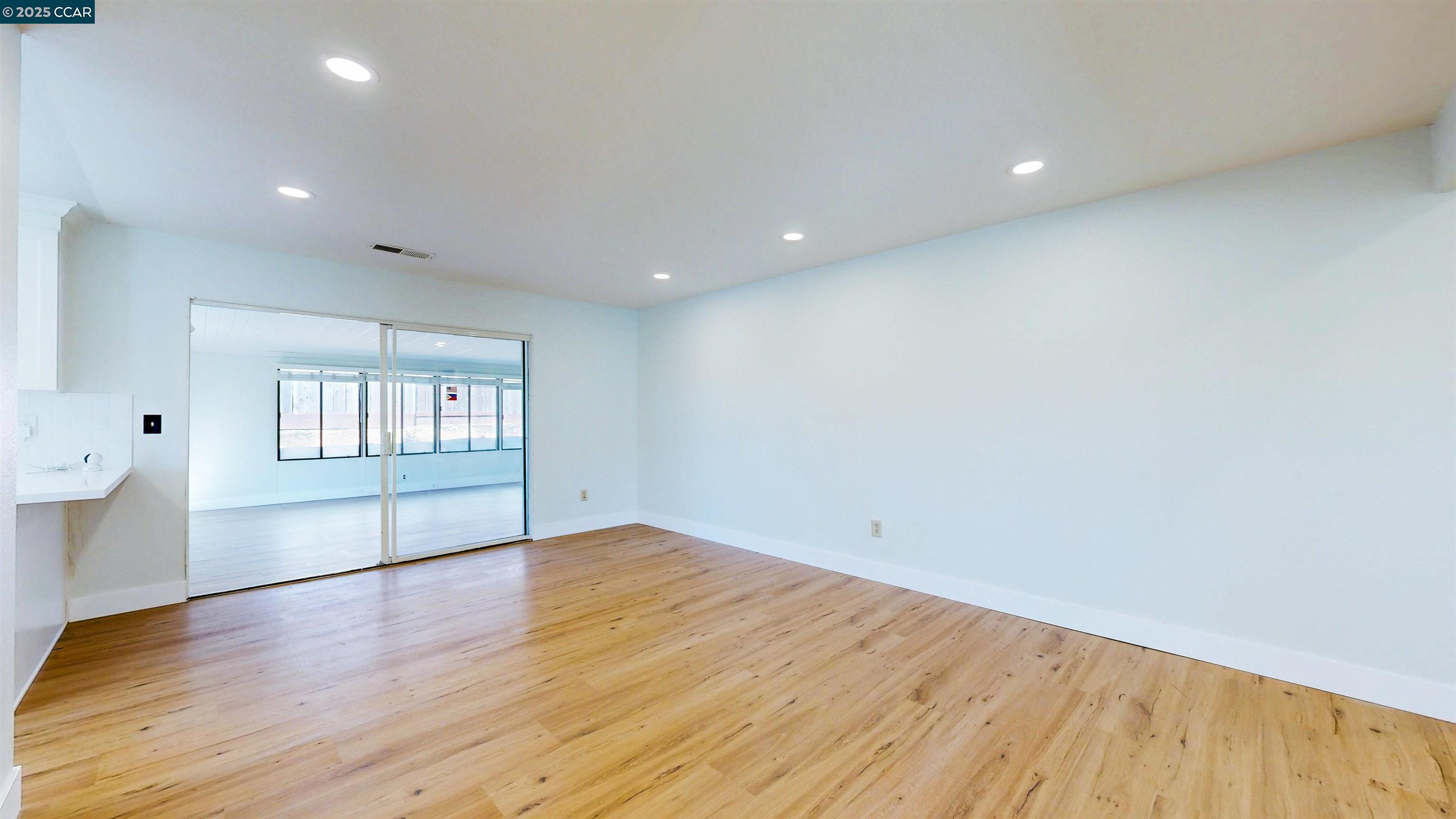 3743 Painted Pony Road Richmond, CA 94803 - Photo 19 of 56 an empty room with wooden floor and windows