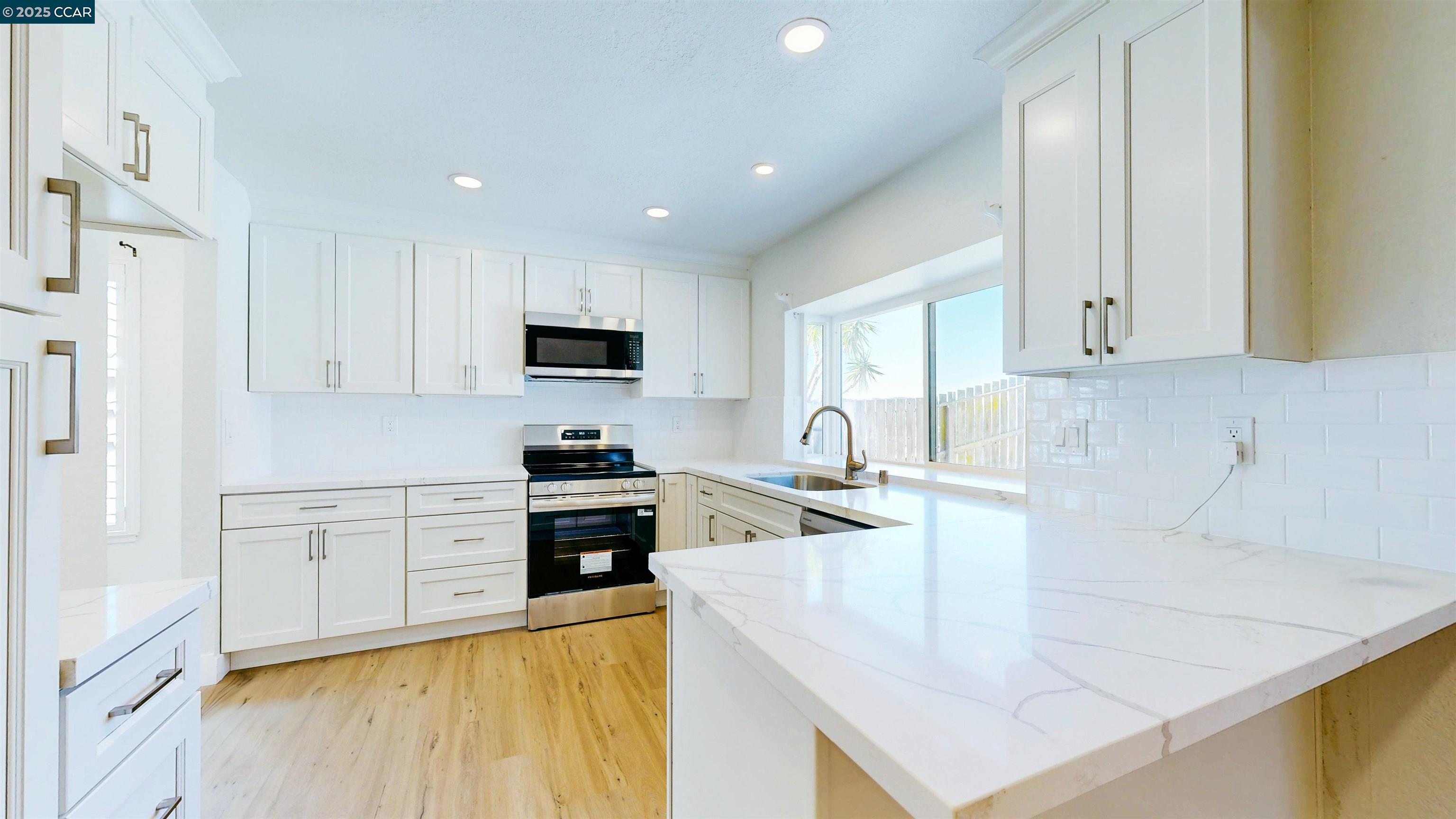 3743 Painted Pony Road Richmond, CA 94803 - Photo 26 of 56 a kitchen with stainless steel appliances granite countertop a sink a stove and a refrigerator