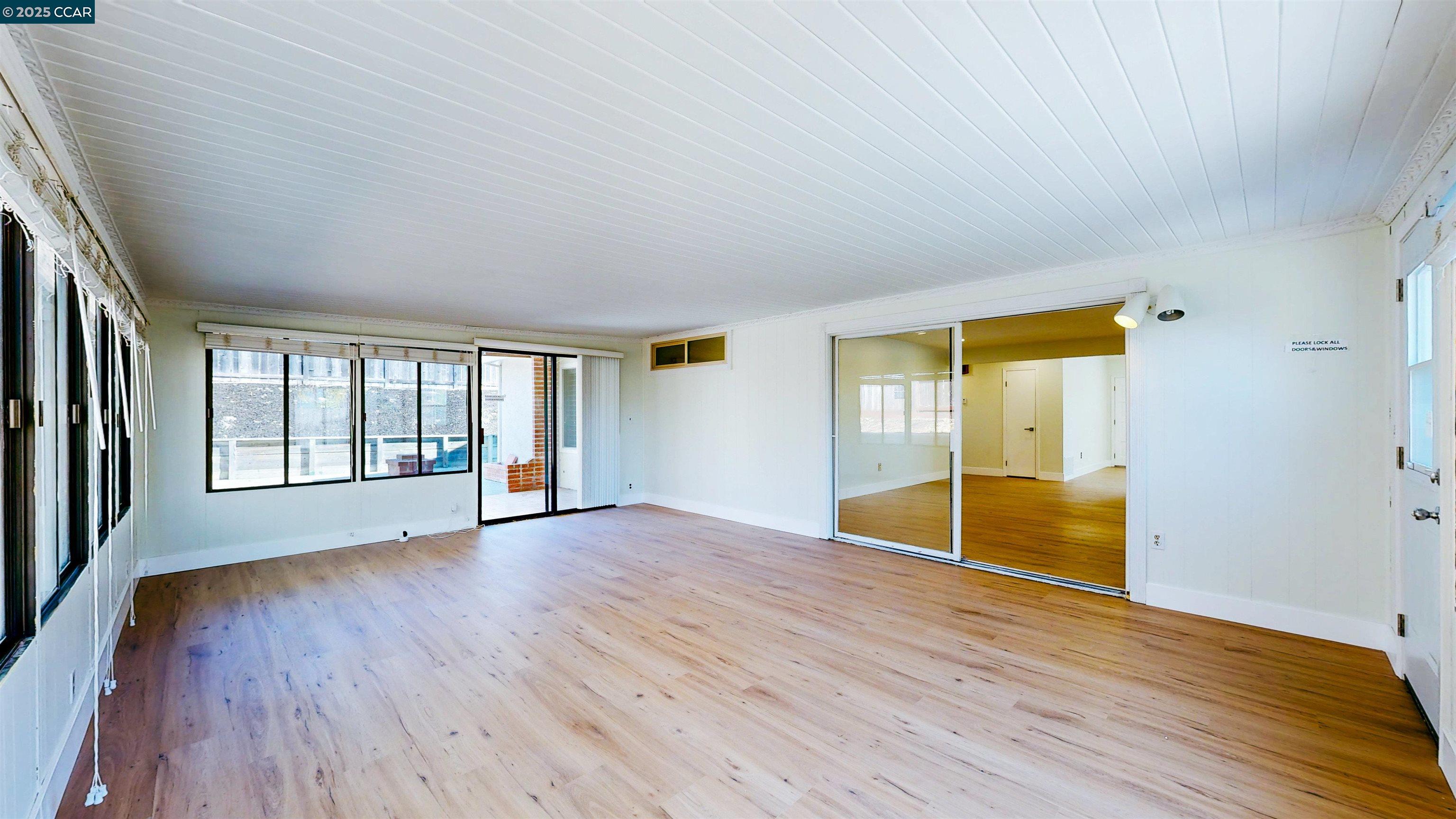 3743 Painted Pony Road Richmond, CA 94803 - Photo 28 of 56 an empty room with wooden floor and windows