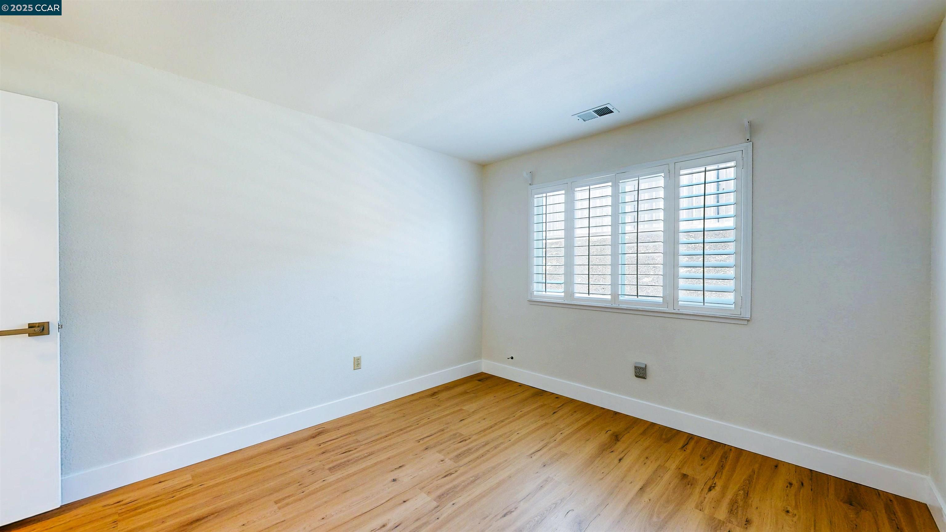 3743 Painted Pony Road Richmond, CA 94803 - Photo 31 of 56 a view of an empty room with wooden floor and a window