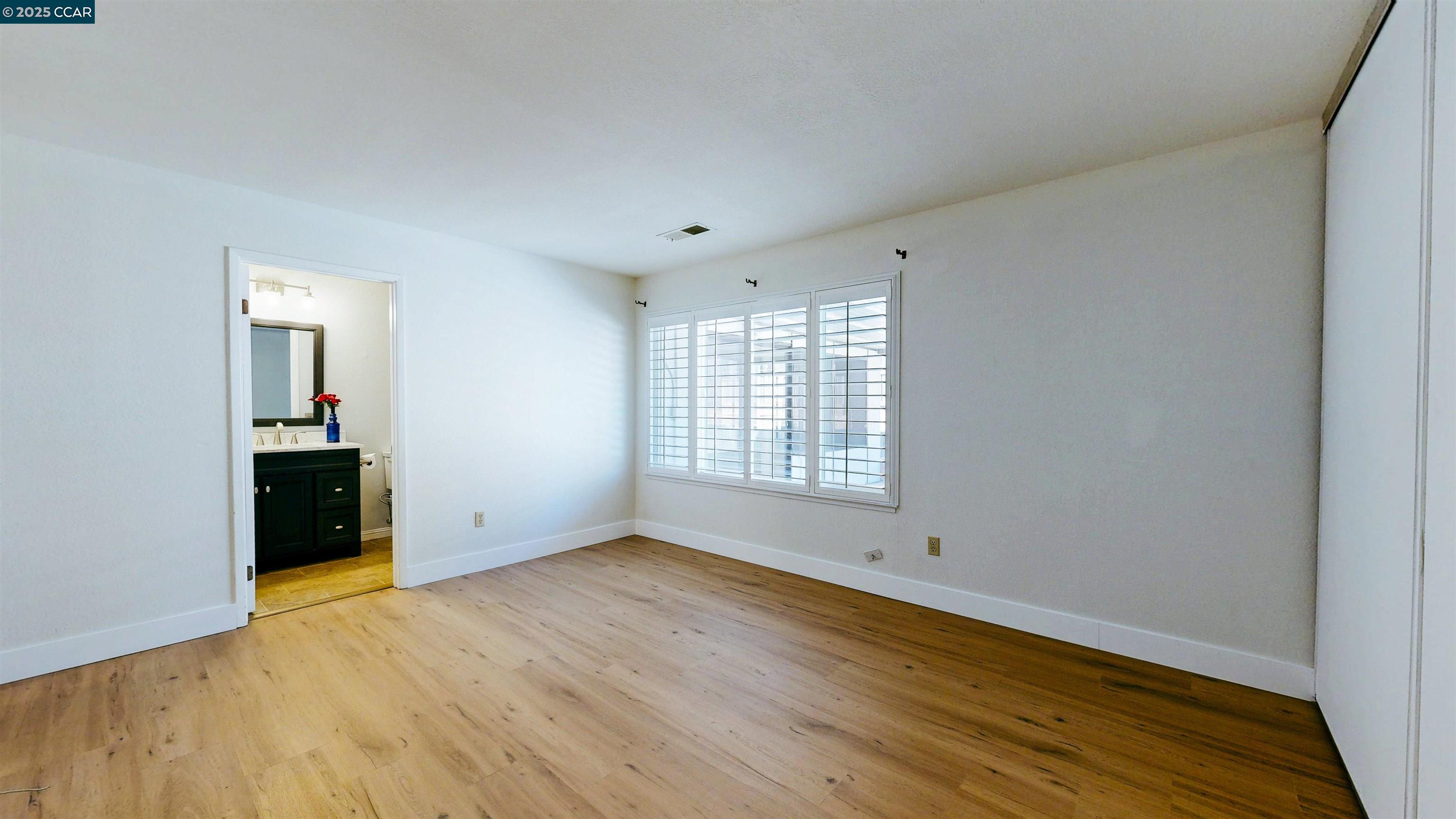 3743 Painted Pony Road Richmond, CA 94803 - Photo 37 of 56 a view of an empty room with wooden floor and a window