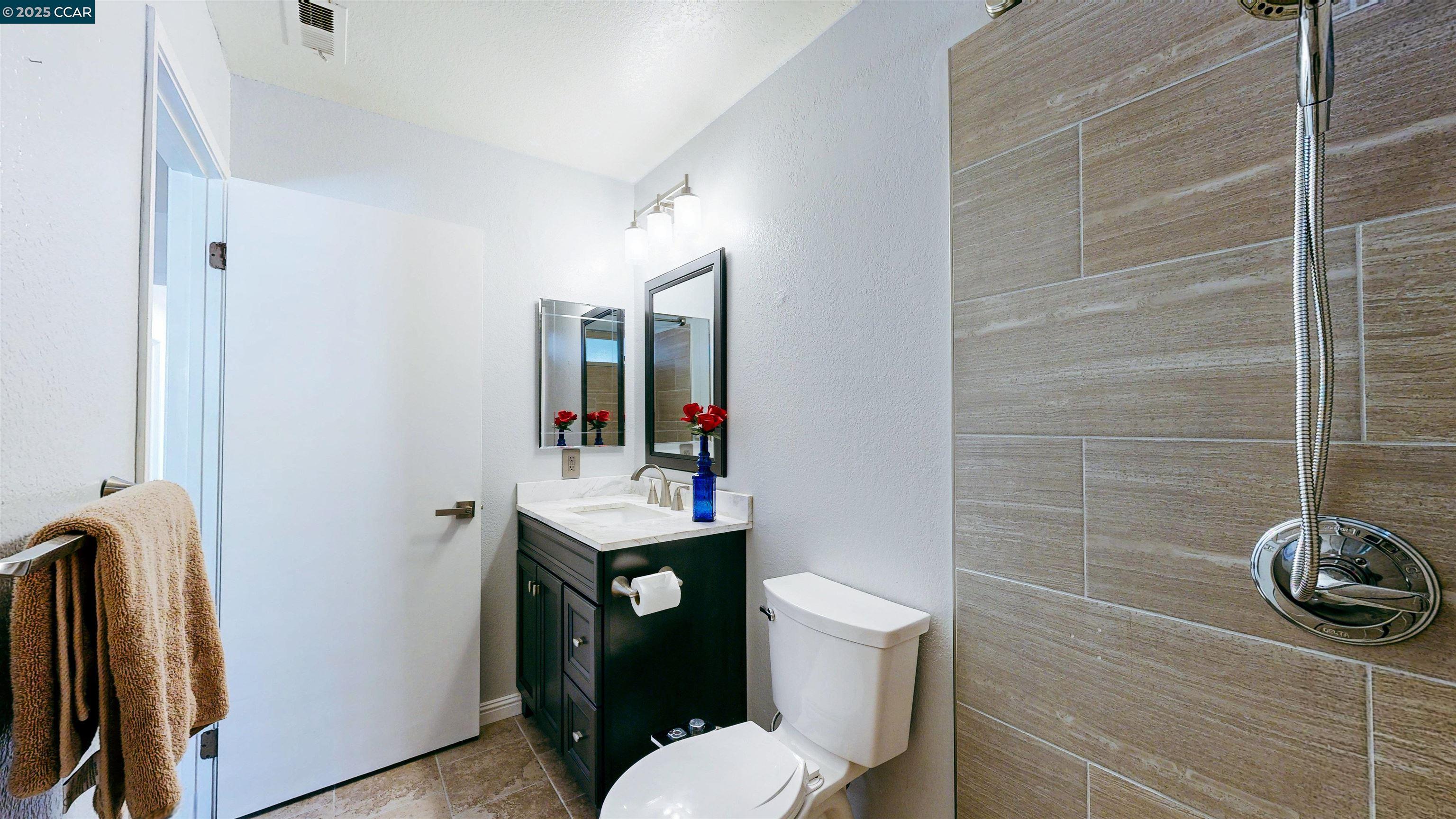 3743 Painted Pony Road Richmond, CA 94803 - Photo 44 of 56 a bathroom with a toilet a sink and mirror