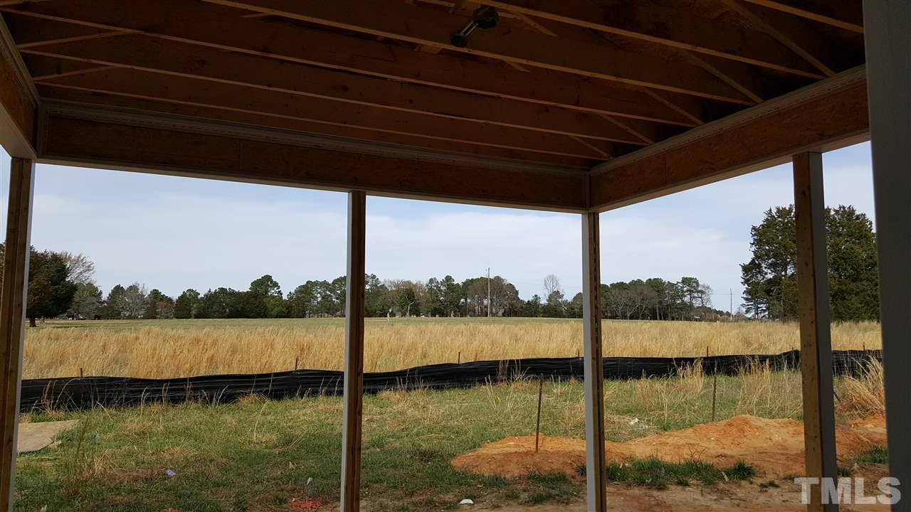 420 Seabring Lane Raleigh, NC 27603 - Photo 11 of 19 Covered back patio with ceiling fan prewire! (please note property extends back farther than black silk fence line)