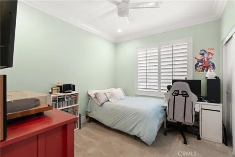a bedroom with a bed and a television