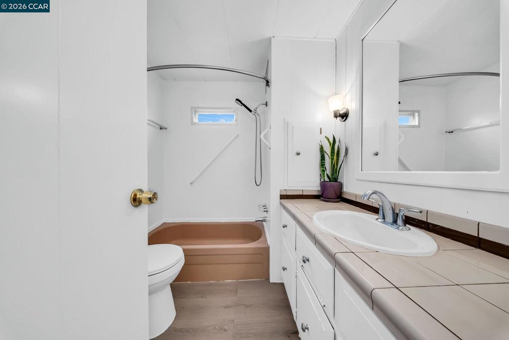 3466 Willow Pass Road Concord, CA 94519 - Photo 15 of 24 a bathroom with a granite countertop bathtub shower sink vanity and toilet