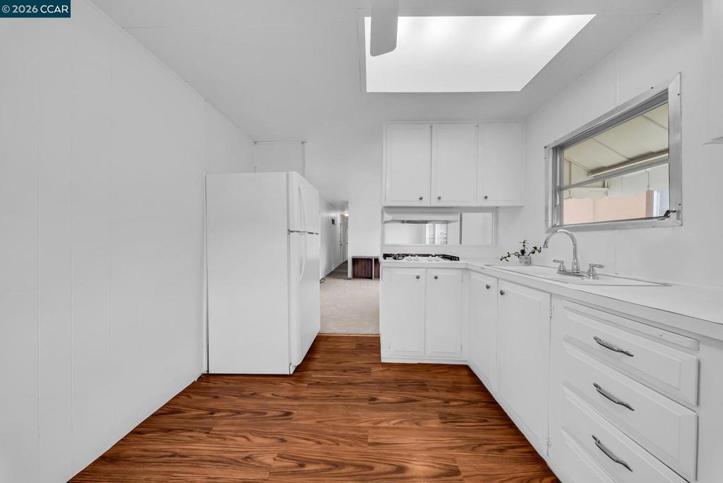 3466 Willow Pass Road Concord, CA 94519 - Photo 6 of 24 a kitchen with white cabinets and white appliances