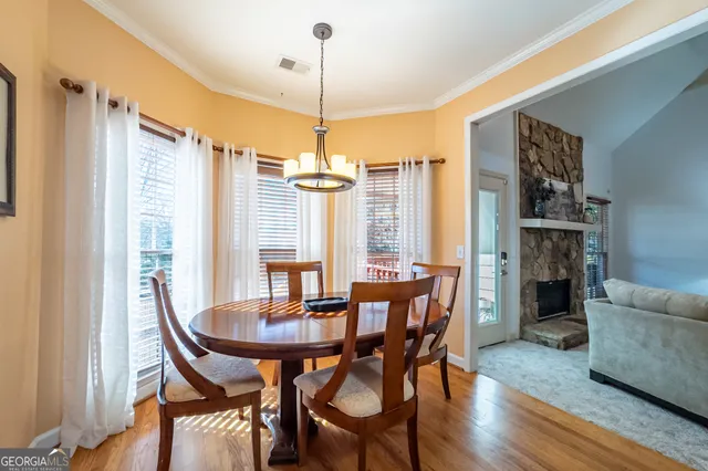 a view of a dining room with furniture window and wooden floor