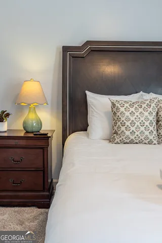 a bedroom with a bed and lamp