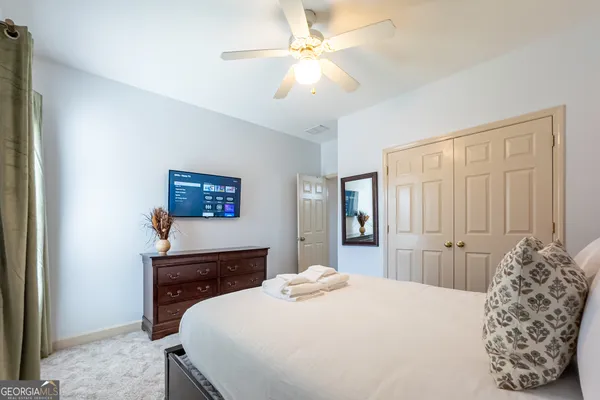 a bedroom with a bed and a chandelier