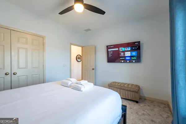 a bedroom with a bed and a chandelier