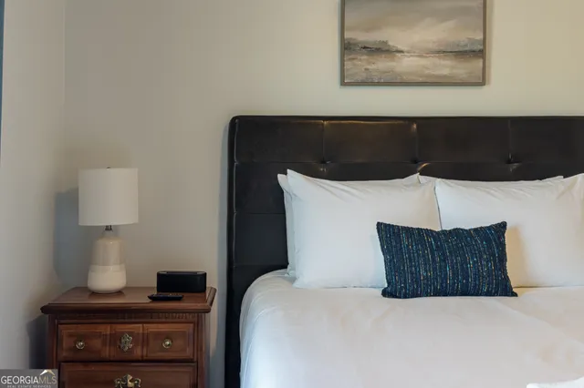 a bedroom with a bed and a night stand