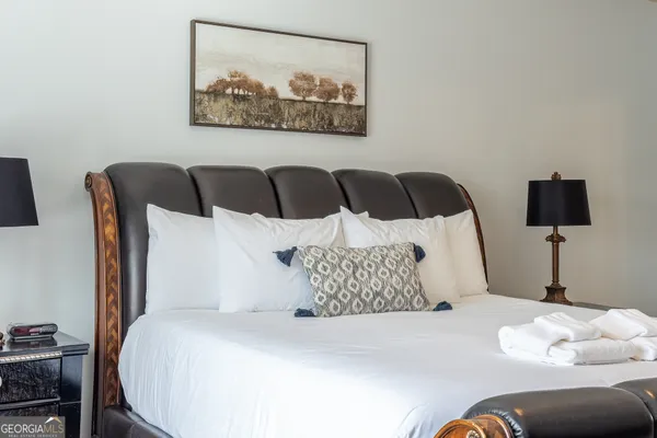 a large bed sitting in a bedroom next to a couch