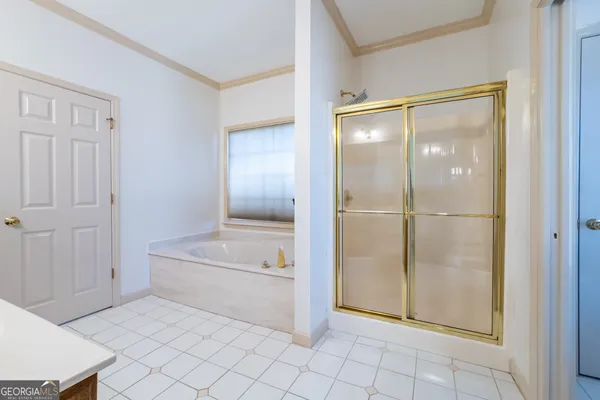 a bathroom with a tub and shower