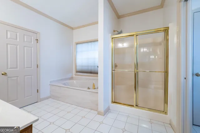 a bathroom with a tub and shower