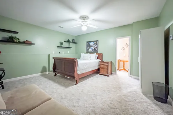 a spacious bedroom with a bed and a chandelier