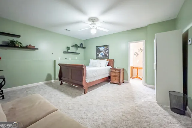 a spacious bedroom with a bed and a chandelier