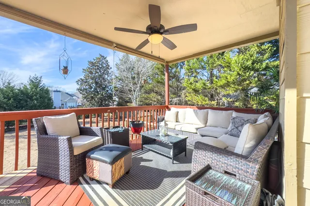 a roof deck with couches and wooden floor
