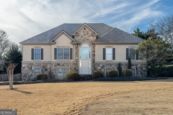 a front view of a house with a yard