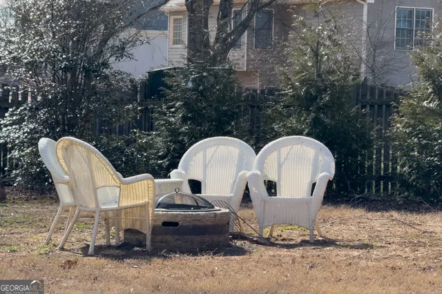 a front view of a house with garden yard and outdoor seating