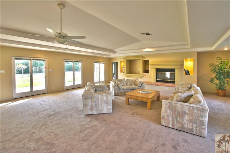 78491 Avenue 41 Bermuda Dunes, CA 92203 - Photo 7 of 16 a living room with furniture and a chandelier