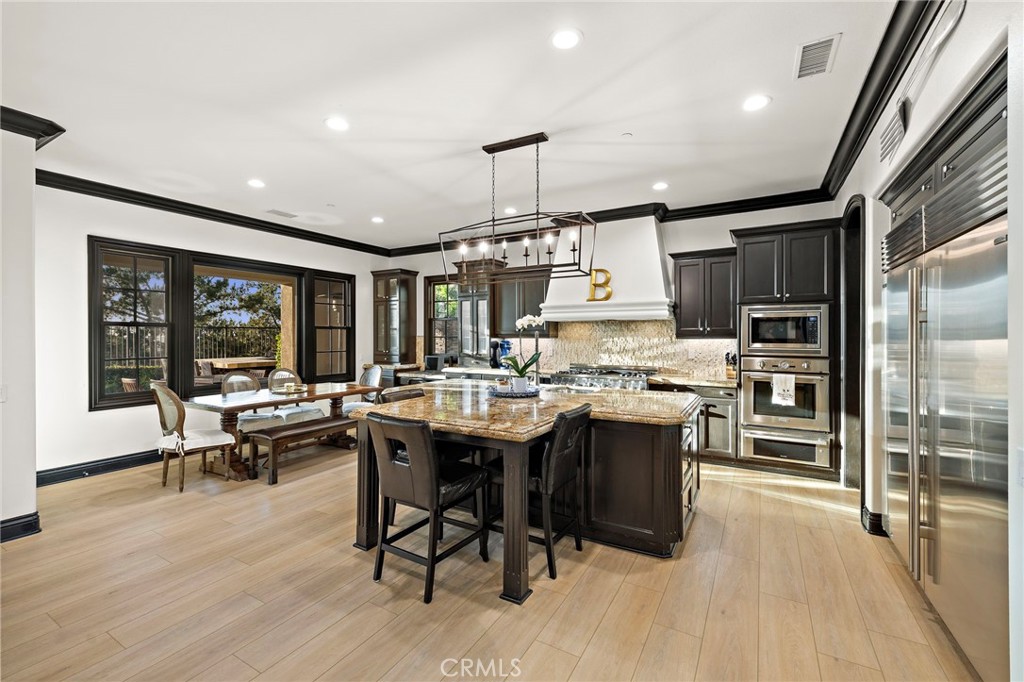 2 Galaxy Isle Ladera Ranch, CA 92694 - Photo 13 of 69 a kitchen with a table chairs refrigerator and cabinets