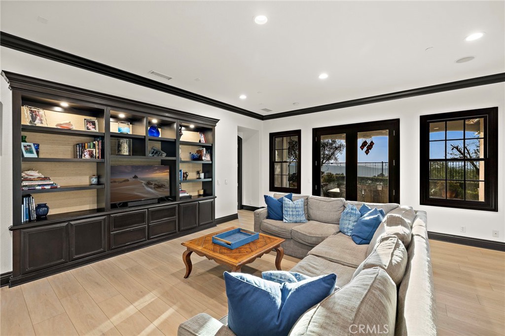 2 Galaxy Isle Ladera Ranch, CA 92694 - Photo 24 of 69 a living room with furniture a floor to ceiling window and flat screen tv