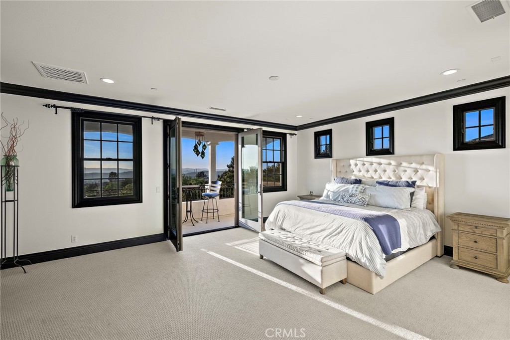 2 Galaxy Isle Ladera Ranch, CA 92694 - Photo 25 of 69 a spacious bedroom with a large bed and a window