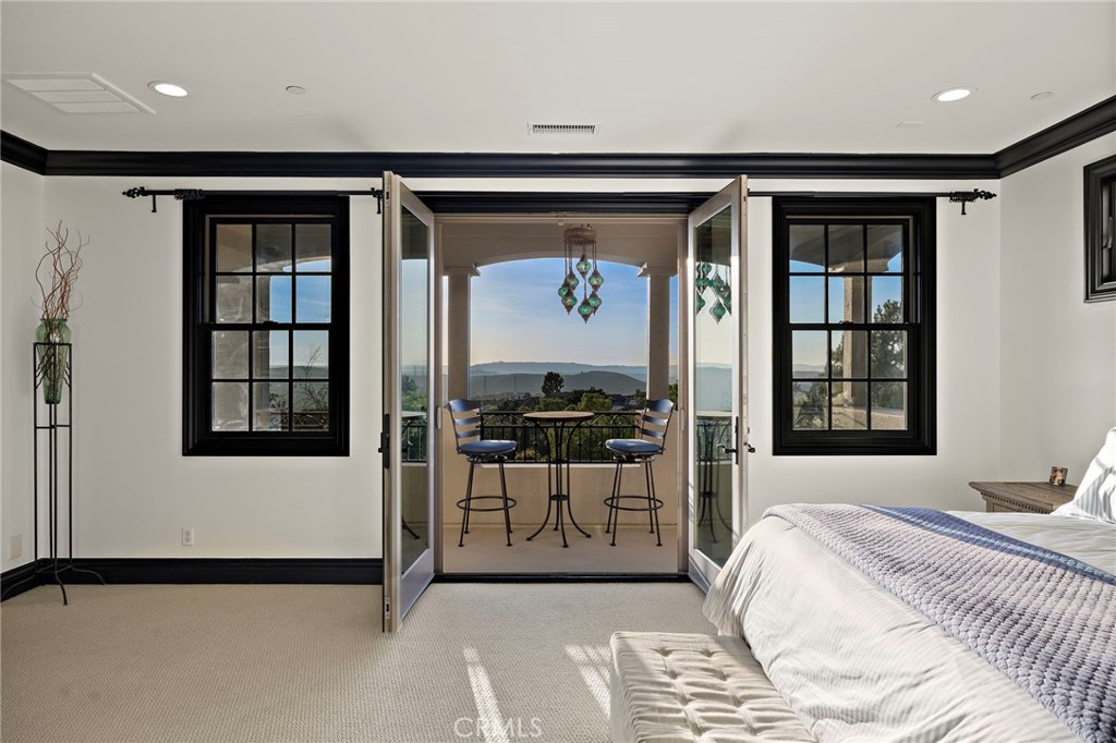 2 Galaxy Isle Ladera Ranch, CA 92694 - Photo 27 of 69 a bedroom with a bed and glass window