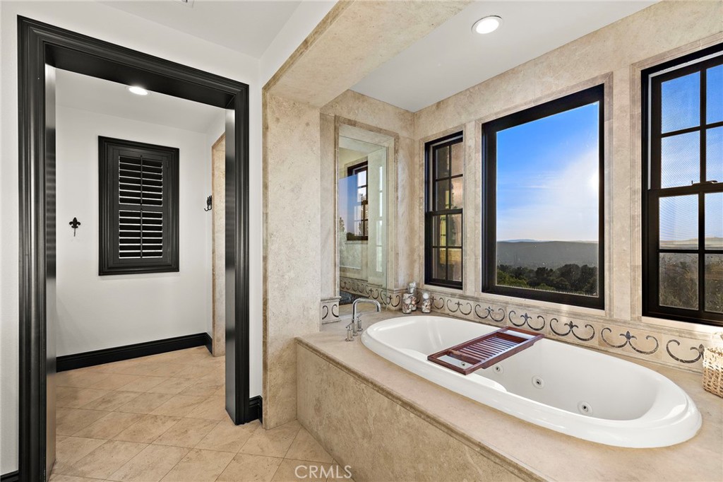 2 Galaxy Isle Ladera Ranch, CA 92694 - Photo 30 of 69 a bathroom with a tub a sink and a mirror