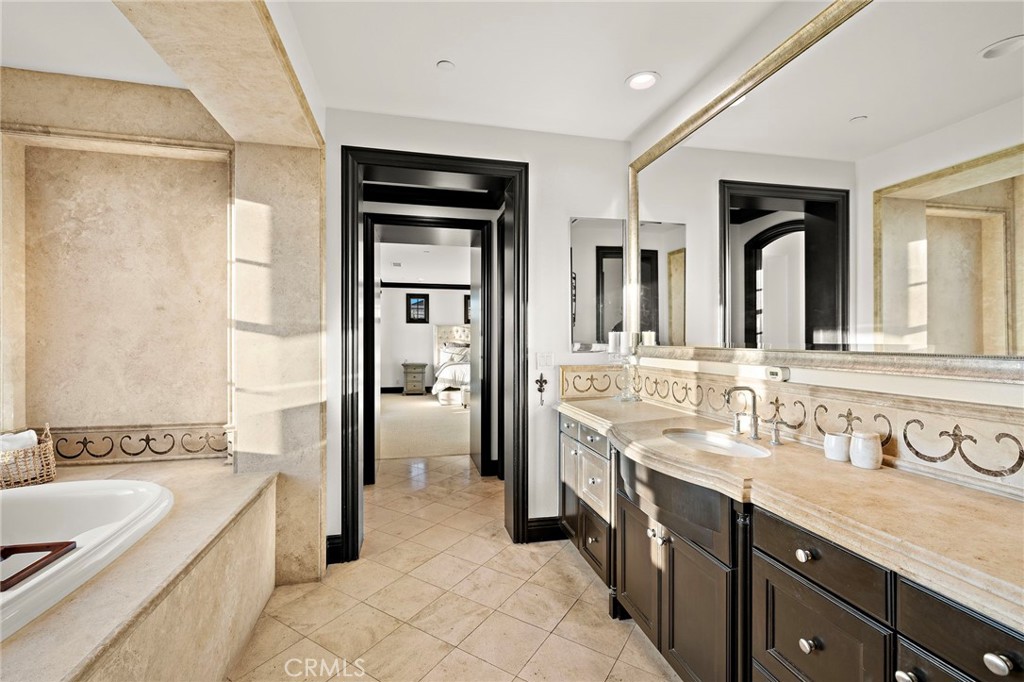 2 Galaxy Isle Ladera Ranch, CA 92694 - Photo 31 of 69 a spacious bathroom with a double vanity sink a mirror and a bathtub