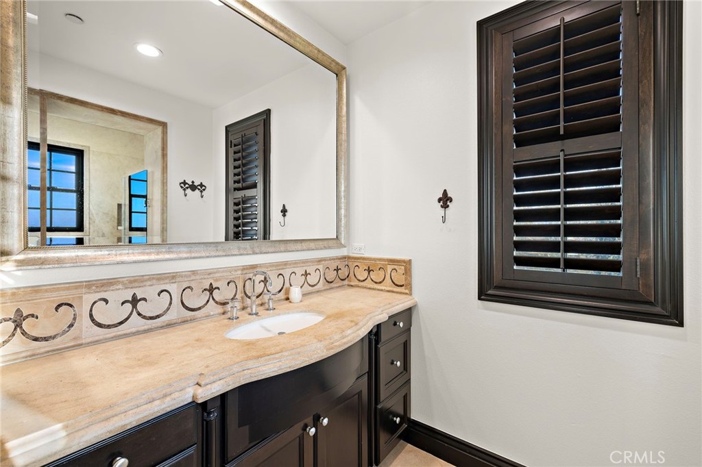 2 Galaxy Isle Ladera Ranch, CA 92694 - Photo 32 of 69 a bathroom with a sink and a mirror