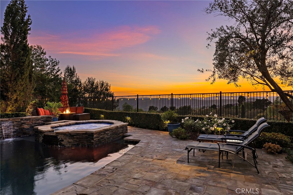 2 Galaxy Isle Ladera Ranch, CA 92694 - Photo 51 of 69 a view of swimming pool with outdoor seating and trees in the background
