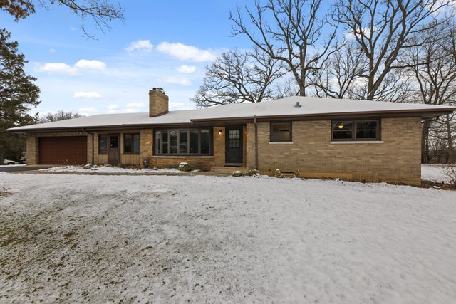 28W777 Garys Mill Road Winfield, IL 60190 - Photo 2 of 47 a front view of a house with a yard and garage