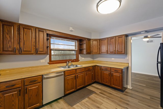 28W777 Garys Mill Road Winfield, IL 60190 - Photo 12 of 47 a kitchen with sink cabinets and wooden floor