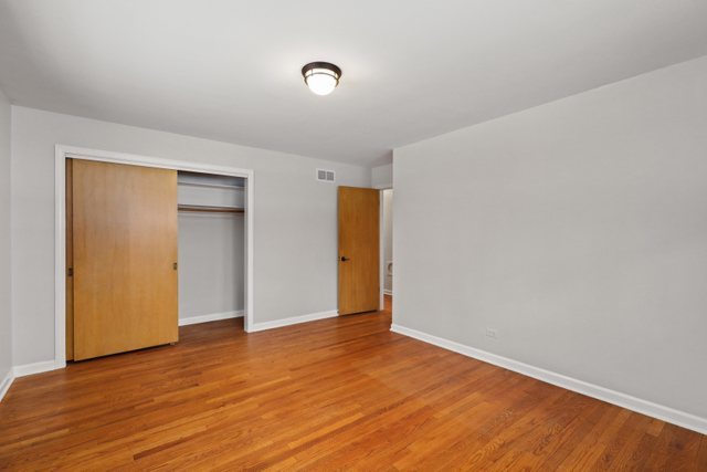 28W777 Garys Mill Road Winfield, IL 60190 - Photo 15 of 47 a view of an empty room with wooden floor and closet
