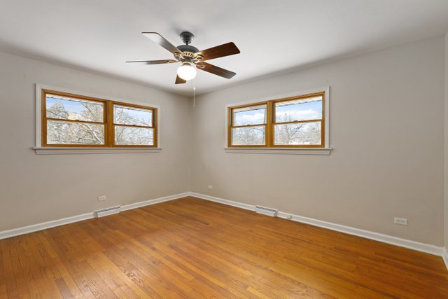 28W777 Garys Mill Road Winfield, IL 60190 - Photo 16 of 47 a view of an empty room with wooden floor and a window