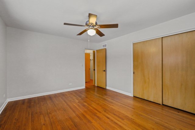 28W777 Garys Mill Road Winfield, IL 60190 - Photo 17 of 47 a view of an empty room with wooden floor and a window