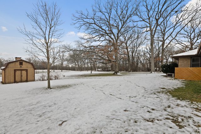28W777 Garys Mill Road Winfield, IL 60190 - Photo 32 of 47 a white house that has a tree in front of it