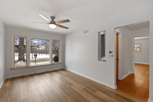 28W777 Garys Mill Road Winfield, IL 60190 - Photo 9 of 47 wooden floor in an empty room with a window