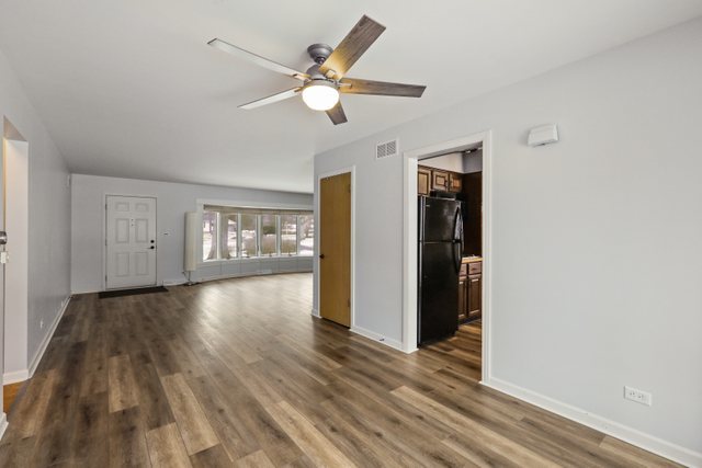 28W777 Garys Mill Road Winfield, IL 60190 - Photo 10 of 47 a view of an empty room with wooden floor and window