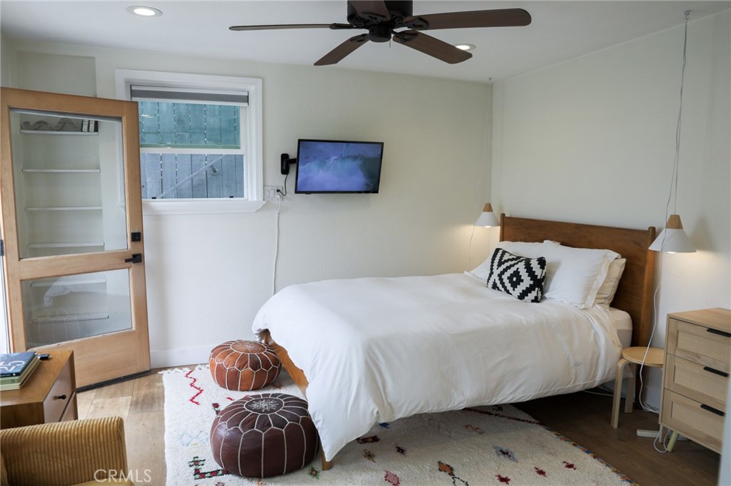 160 Avenida Florencia, Unit B San Clemente, CA 92672 - Photo 14 of 48 a bedroom with a bed and wooden floor