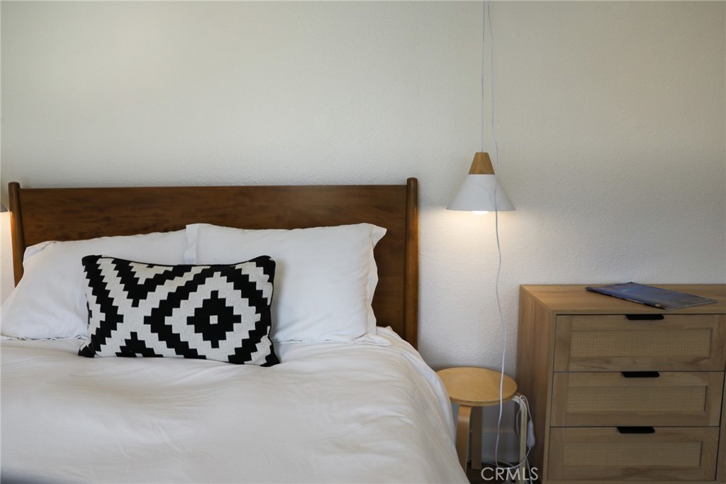 160 Avenida Florencia, Unit B San Clemente, CA 92672 - Photo 21 of 48 a bed sitting in a bedroom next to a window