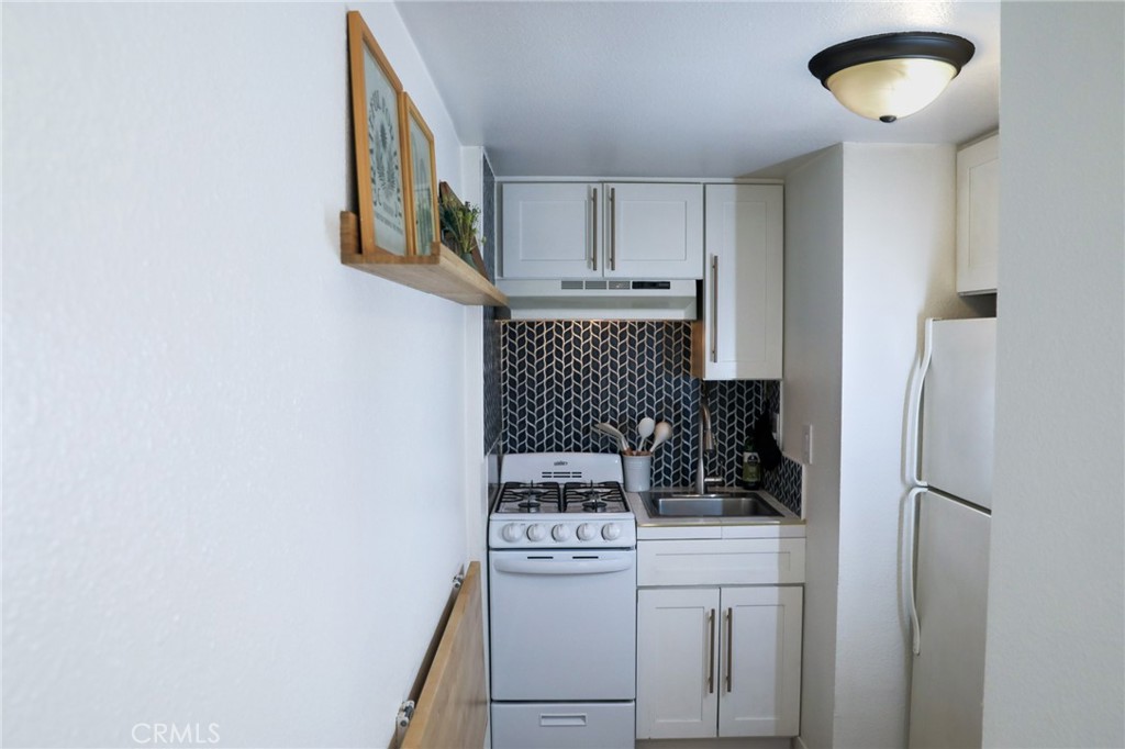 160 Avenida Florencia, Unit B San Clemente, CA 92672 - Photo 25 of 48 a kitchen with stainless steel appliances a refrigerator and cabinets