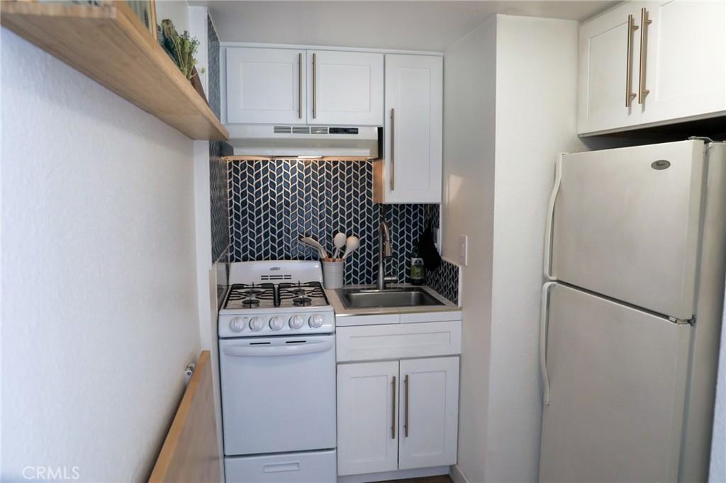 160 Avenida Florencia, Unit B San Clemente, CA 92672 - Photo 26 of 48 a white refrigerator freezer and a stove sitting inside of a kitchen