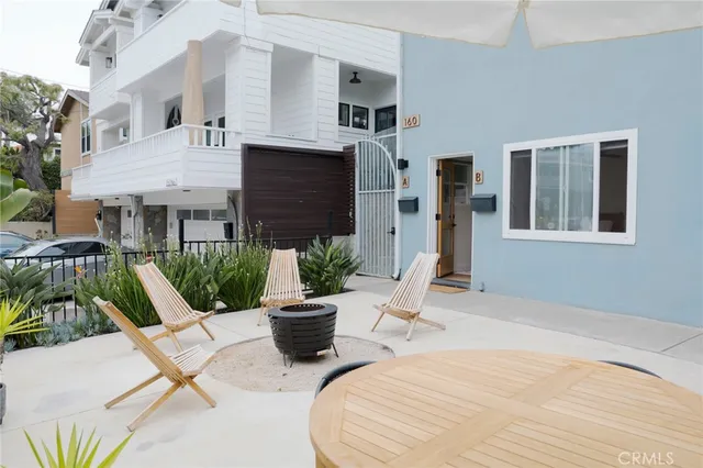 a view of a house with backyard and sitting area