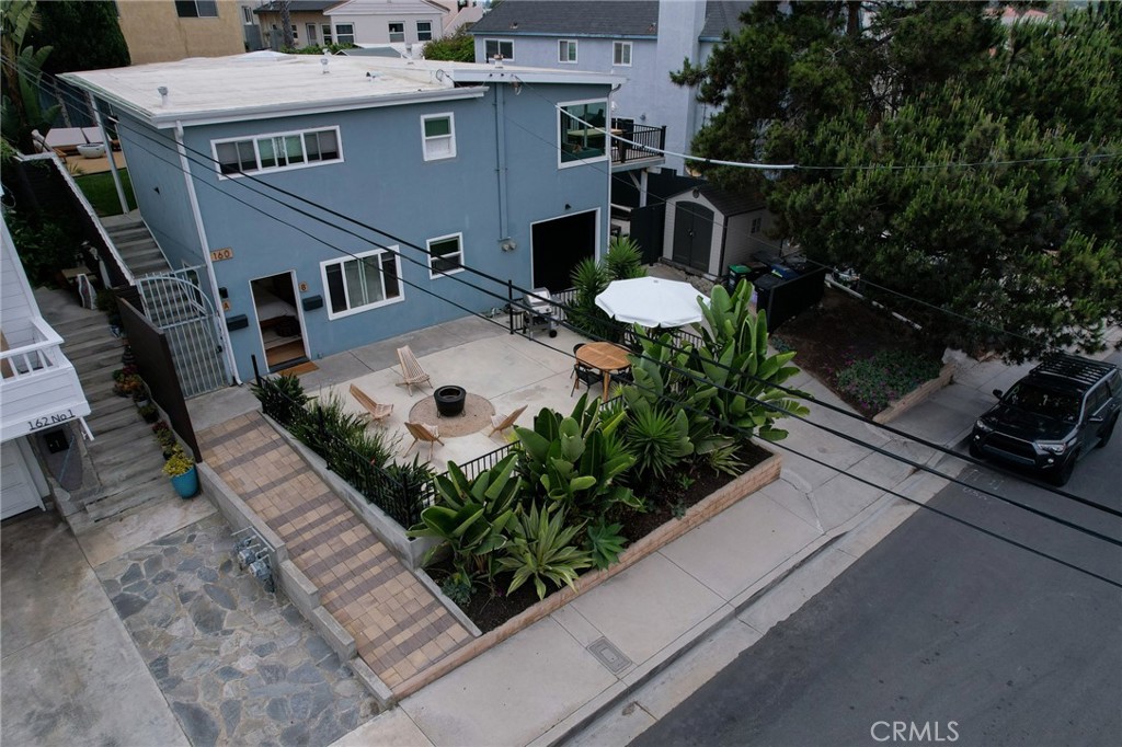 160 Avenida Florencia, Unit B San Clemente, CA 92672 - Photo 37 of 48 an aerial view of a house with a yard fire pit and furniture