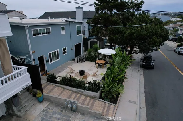 a backyard of a house with table and chairs