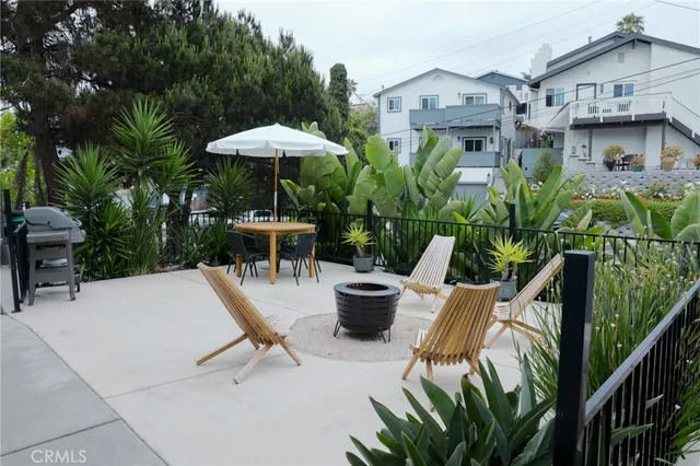 a view of a patio with table and chairs potted plants