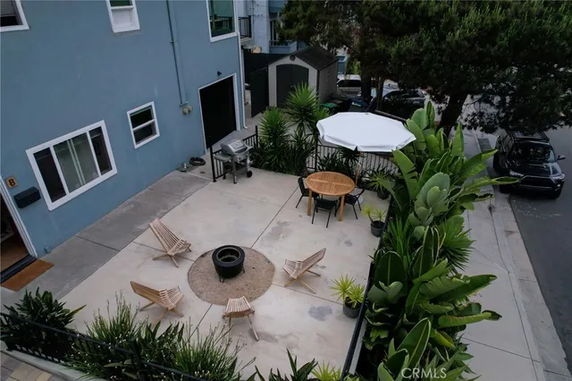 a backyard of a house with table and chairs